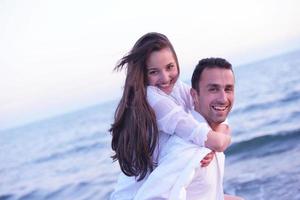 young couple  on beach have fun photo