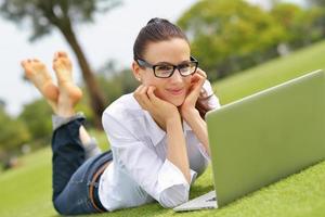 woman with laptop in park photo