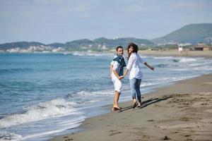 happy young couple have fun at beautiful beach photo