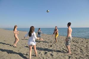 young people group have fun and play beach volleyball photo