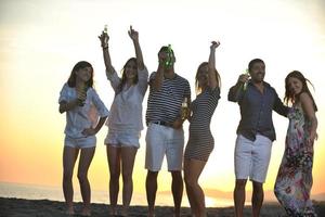 Group of young people enjoy summer  party at the beach photo