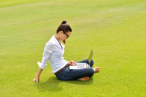 woman with laptop in park photo