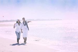 happy young couple have fun at beautiful beach photo