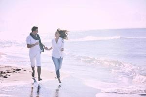 happy young couple have fun at beautiful beach photo