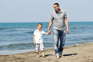 happy father and son have fun and enjoy time on beach photo