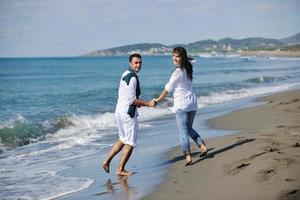 happy young couple have fun at beautiful beach photo