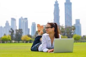 woman with laptop in park photo