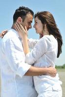 happy young couple have fun on beach photo