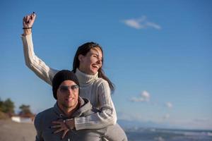 couple having fun at beach during autumn photo