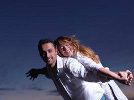 young couple  on beach have fun photo