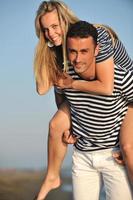 happy young couple have romantic time on beach photo