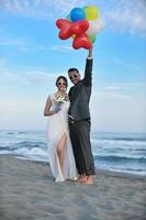 romantic beach wedding at sunset photo