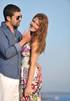 happy young couple have romantic time on beach photo