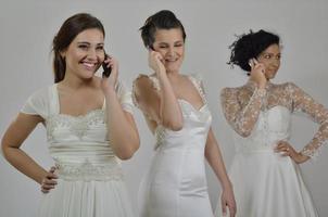 portrait of a three beautiful woman in wedding dress photo