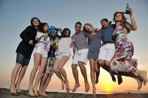 Group of young people enjoy summer  party at the beach photo