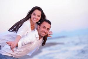 young couple  on beach have fun photo