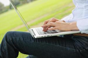 woman with laptop in park photo