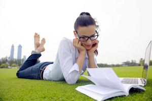 woman with laptop in park photo