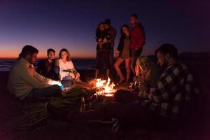 Friends having fun at beach on autumn day photo