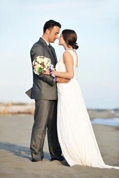 romantic beach wedding at sunset photo
