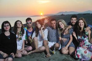 Group of young people enjoy summer  party at the beach photo