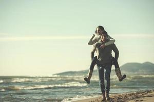 couple having fun at beach during autumn photo