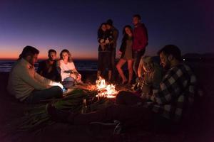 Friends having fun at beach on autumn day photo