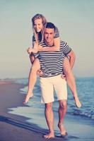 happy young couple have romantic time on beach photo