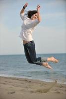 happy young couple have fun on beach photo