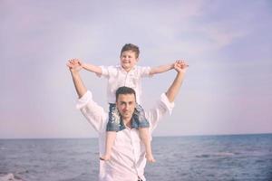 happy father and son have fun and enjoy time on beach photo