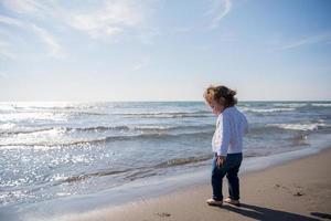 cute little girl at autumn beach photo