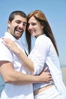 happy young couple have fun on beach photo