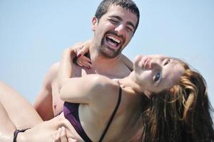 happy young couple have romantic time on beach photo