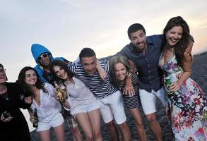 Group of young people enjoy summer  party at the beach photo