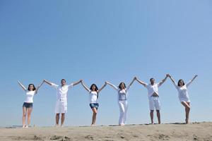 happy people group have fun and running on beach photo