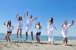 happy young  people group have fun on beach photo