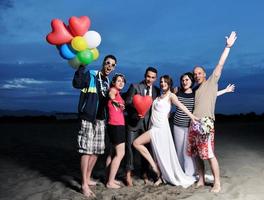 grupo de jóvenes felices divertirse en la playa foto