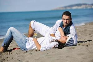 young couple enjoying  picnic on the beach photo