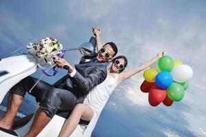 just married couple on the beach ride white scooter photo