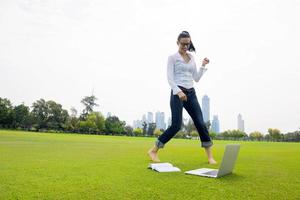 woman with laptop in park photo