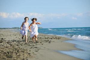 cute little girls running on beach photo