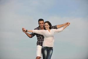 happy young couple have fun on beach photo