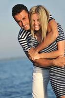 happy young couple have romantic time on beach photo