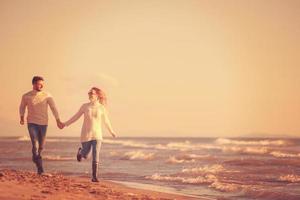 Loving young couple on a beach at autumn sunny day photo