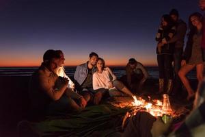 Friends having fun at beach on autumn day photo