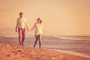 Loving young couple on a beach at autumn sunny day photo