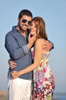 happy young couple have romantic time on beach photo