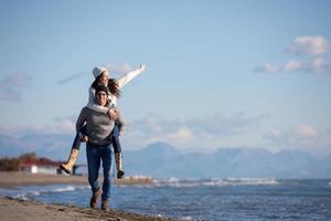 couple having fun at beach during autumn photo