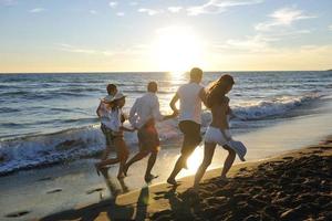 people group running on the beach photo