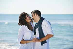 happy young couple have fun at beautiful beach photo